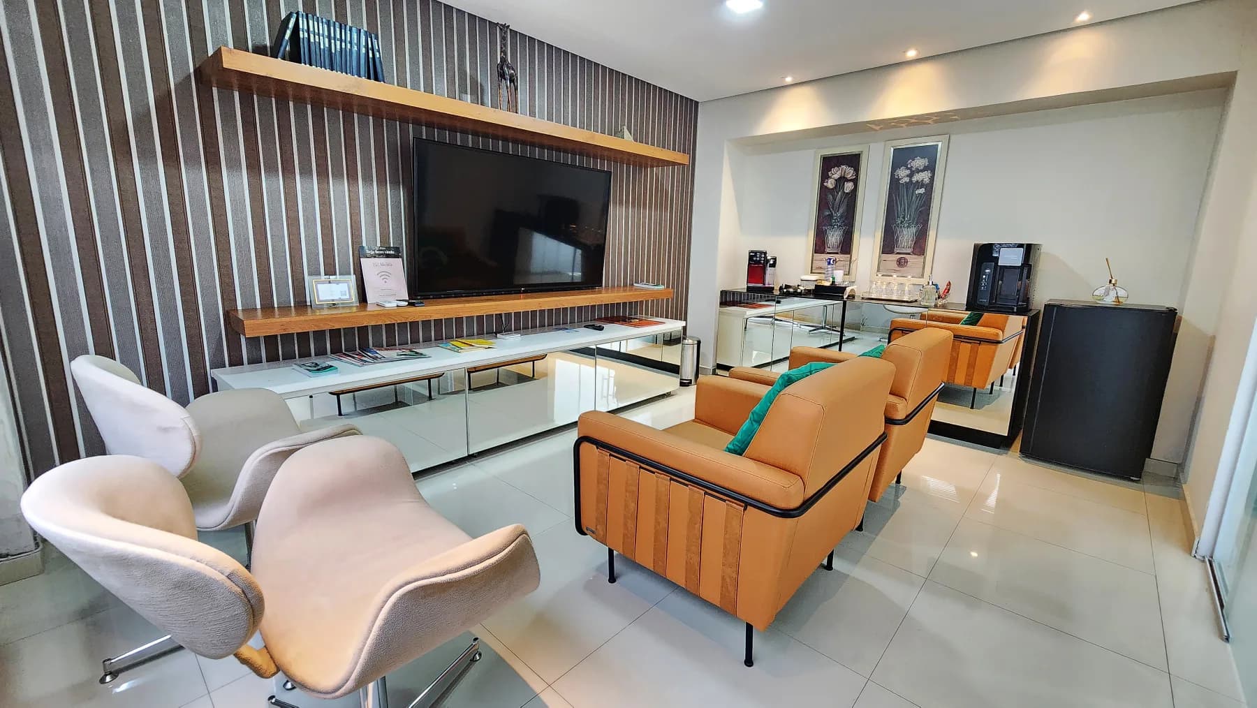Sala de espera da Allegra Odontologia com poltronas e painel de madeira.